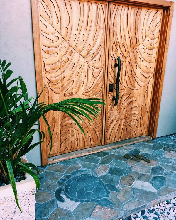 Carved monstera wood doors