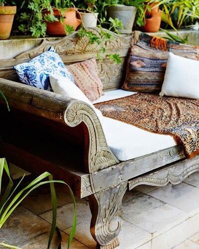 Carved daybed on tropical patio